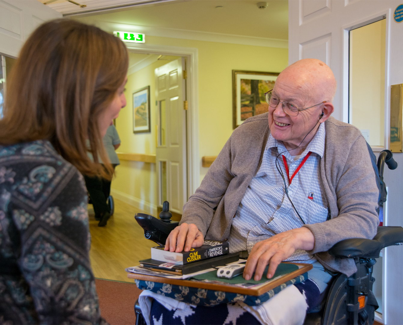 Engage in person image showing a care home manager talking to a resident