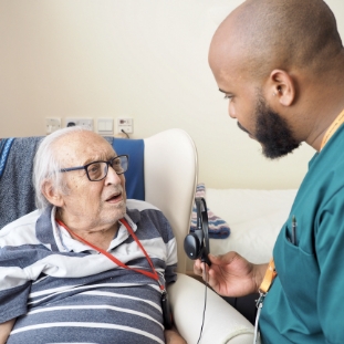 Engage | a member of the Heathlands Village team interacting with a resident