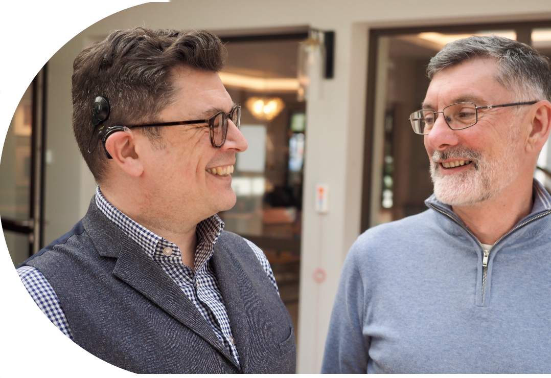Andrew & Padraic facing each other and smiling
