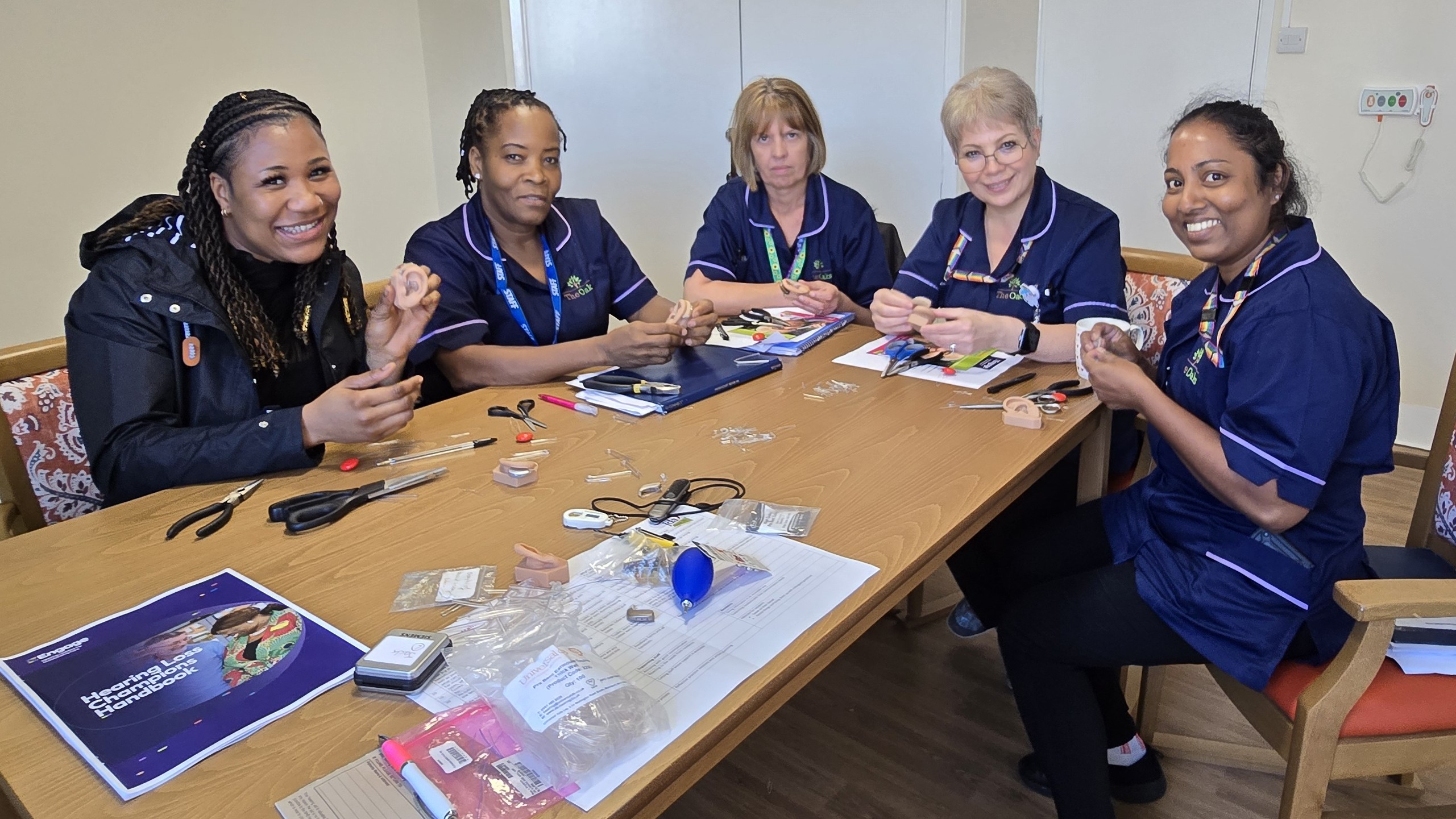 a group of team leaders learning how to support people with hearing loss.
